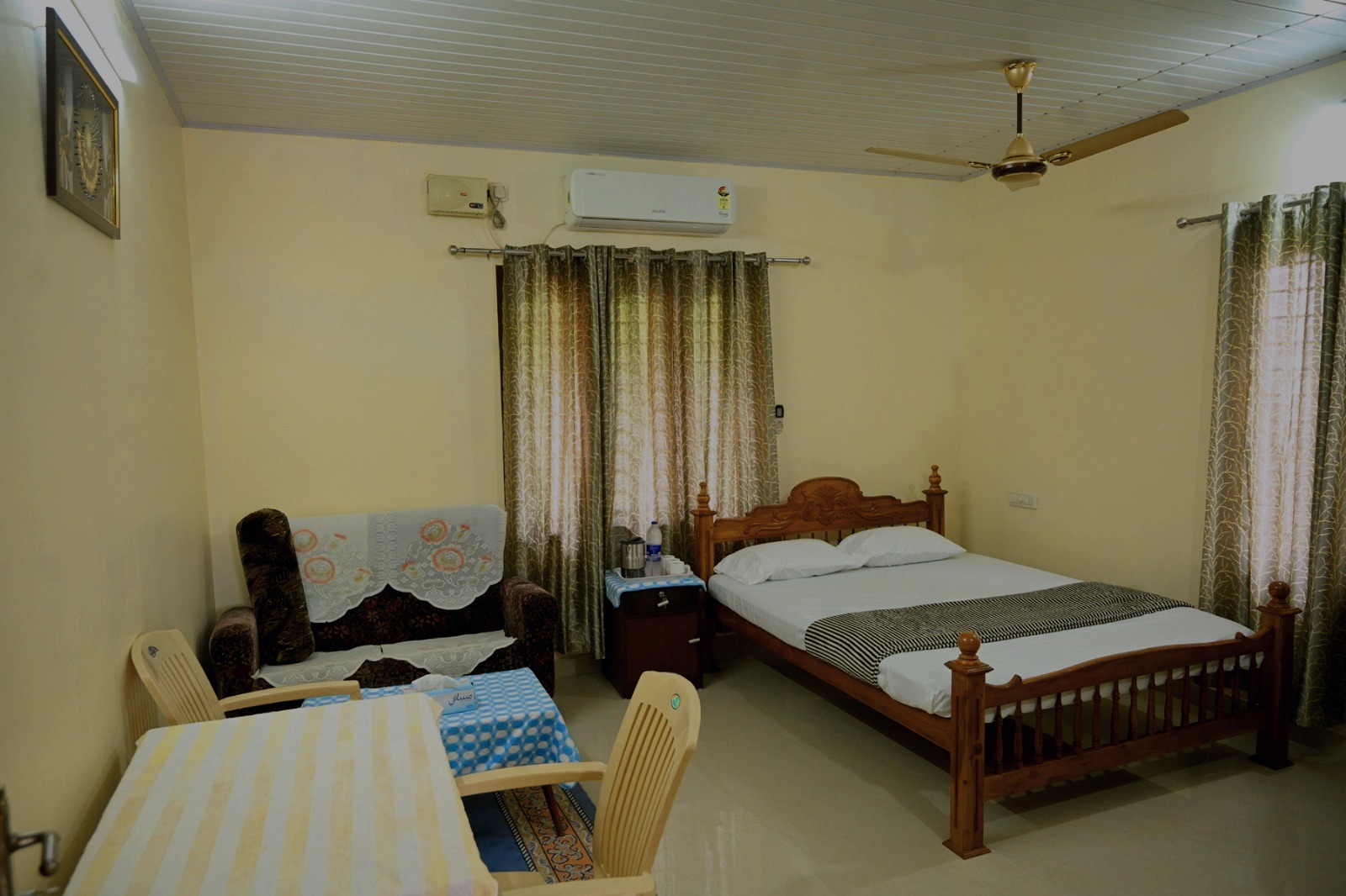 Second bedroom with wooden bed and curtains